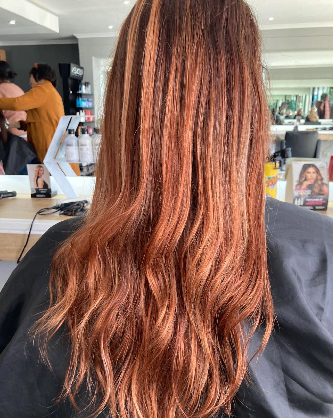 Long copper hair with face-framing highlights, coloured at Liv Hair Studio