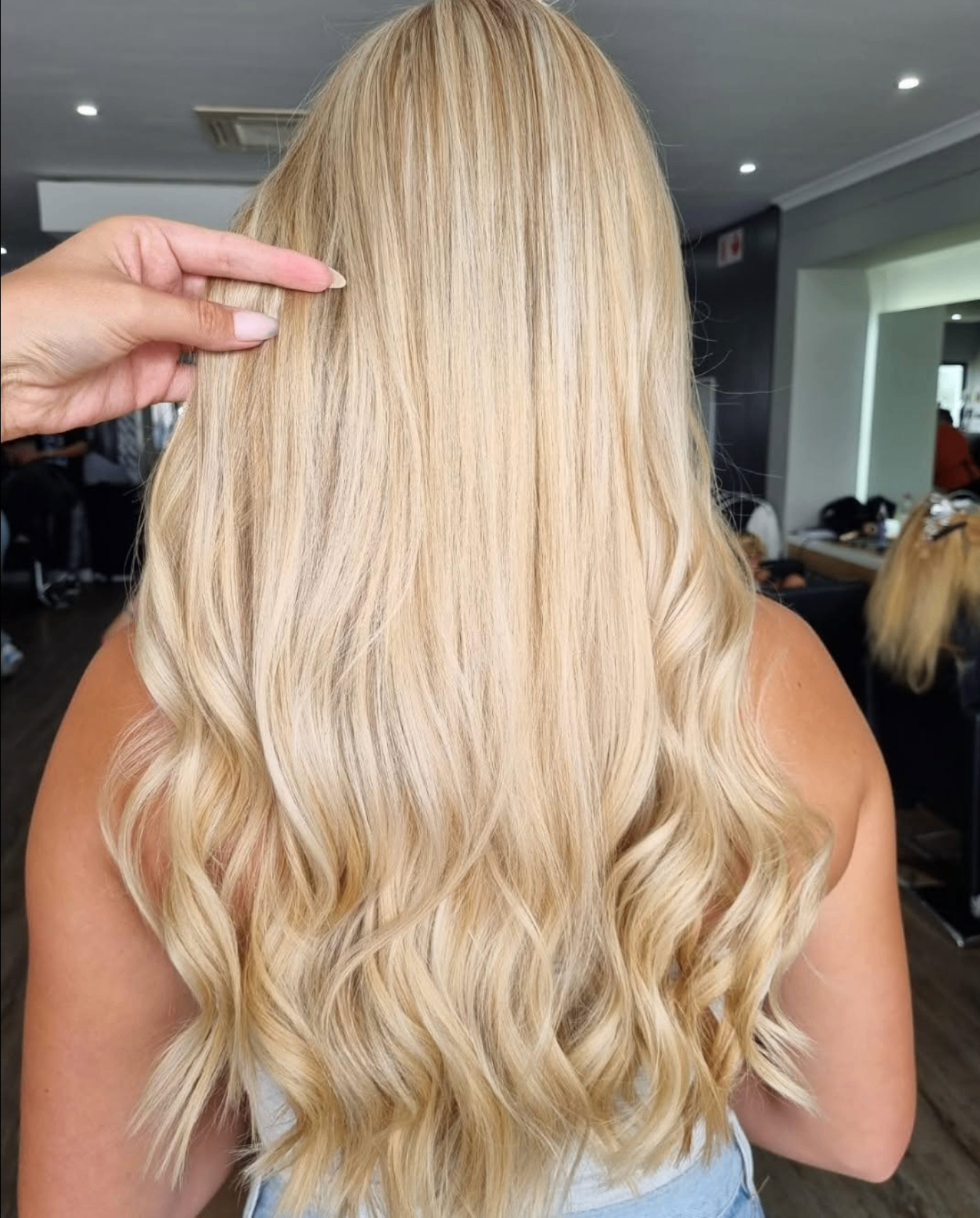 Long butter-blonde hair with soft waves, coloured at Liv Hair Studio