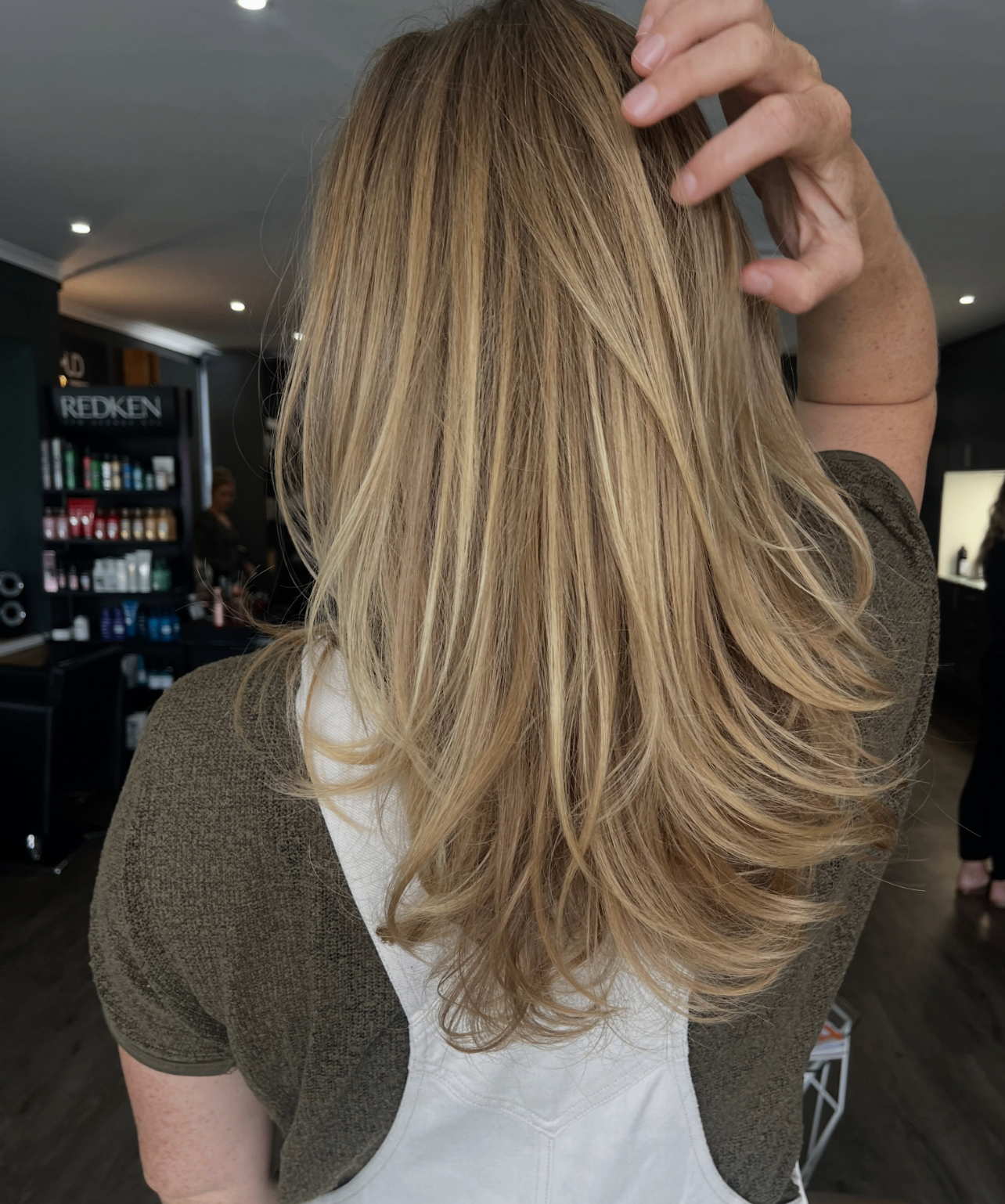 Sun-kissed blonde layers with soft movement styled at Liv Hair Studio