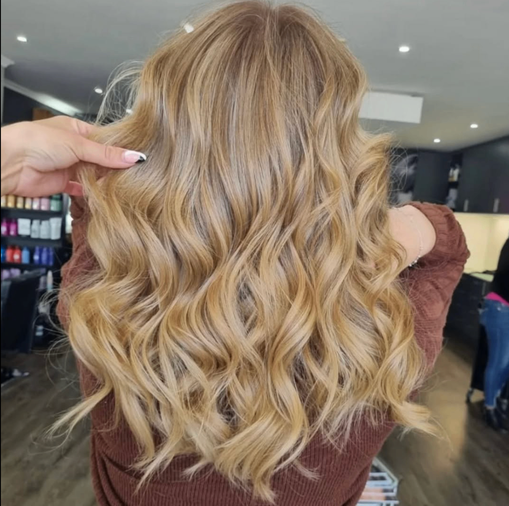 Golden blonde curls on long hair, coloured at Liv Hair Studio